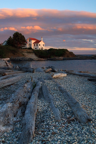 logs leading toward house sunset at Ross Bay, Victoria, British Columbia